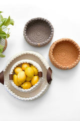 crochet baskets on a table, one with lemons in it thumbnail
