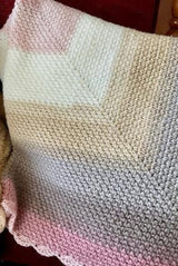 handmade pink, white, and tan moss stitch baby blanket with a scalloped edge thumbnail
