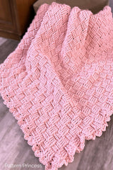 pink blanket draped over basket thumbnail