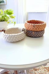 crochet baskets on a table, one with lemons in it thumbnail