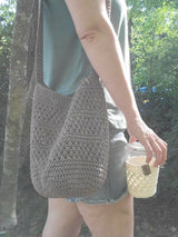 handmade mesh-style crocheted yarn market bag worn by woman thumbnail