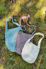 handmade mesh-style crocheted yarn market bags on outdoor ground thumbnail