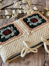 handmade crochet hearthside book sleeve on a wooden surface thumbnail