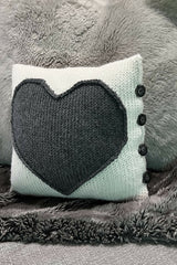pillow with a heart and 4 buttons on a couch thumbnail