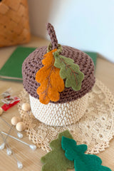 handmade crochet acorn on a wooden table thumbnail