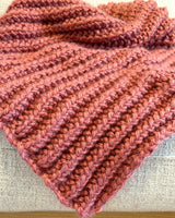 dusty pink knitted mistake rib throw blanket draped on a furniture thumbnail