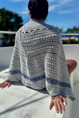 Gray and blue shawl draped over womans shoulders thumbnail