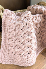 close-up of pink crochet blanket in a basket thumbnail