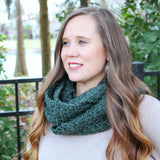 forest green crocheted infinity cowl scarf in sedge stitch worn around the neck of a blonde woman thumbnail