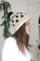 woman wearing a cream and black houndstooth knitted beanie thumbnail