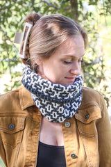 Woman in grey & white cowl outside, looking down thumbnail