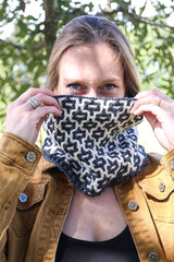 Woman in grey & white cowl outside, looking at camera thumbnail