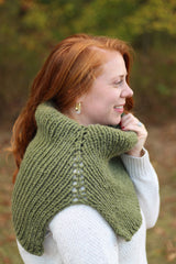 Woman wears a green cowl, looking right thumbnail