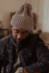 Man in tan hat, looking down thumbnail