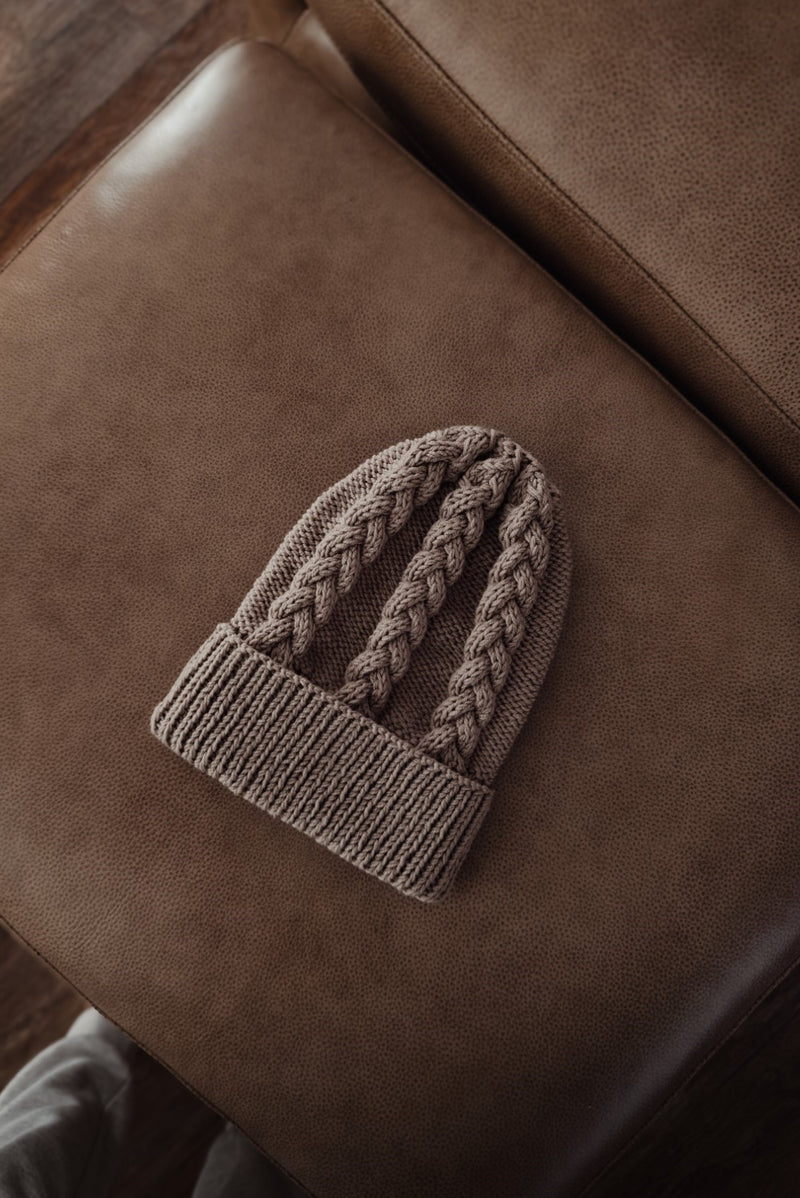 Tan hat on leather couch