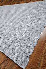 Grey shawl spread on wood floor thumbnail