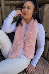 Seated woman wearing short pink scarf thumbnail
