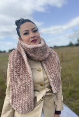 Woman in field with brown scarf wrapped around neck thumbnail