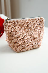 Pale pink bag on white desk thumbnail