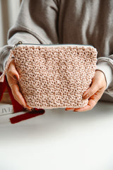 Woman holding pale pink bag thumbnail