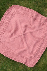 Overhead shot of pink blanket on grass.  thumbnail