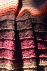 Close up of red-purple knit blanket thumbnail