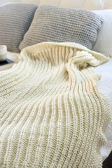 Cream ribbed blanket on bed.  thumbnail