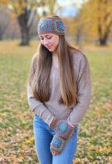 Woman with long hair wears crochet headband and mitts outdoors.  thumbnail