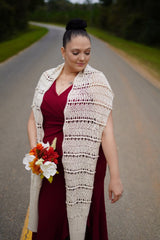 Woman wears crochet wrap as scarf, over cranberry dress with bouquet.  thumbnail