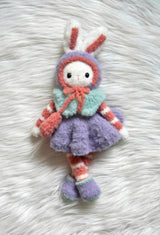 Fuzzy crochet bunny with purple skirt, red & white striped arms & legs, and aqua vest.  thumbnail