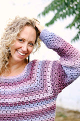 Close up of raglan shaping and sleeve of purple & pink crochet sweater.  thumbnail