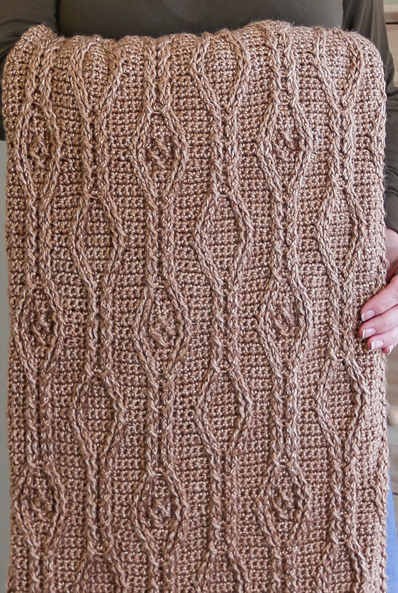 Close up of diamond texture on crochet blanket. 