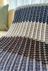 Close up of color blocked striped blanket, showing ridged texture.  thumbnail