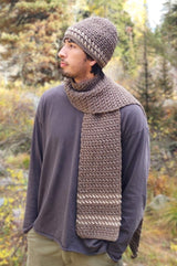 Male model wears taupe hat and matching scarf, standing outdoors.  thumbnail