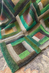 Close up of knit log cabin blanket in shades of green, cream, and rust.  thumbnail