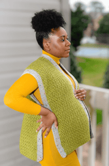 Side view of pregnant woman in yellow dress showing large split hem on ruana vest.  thumbnail