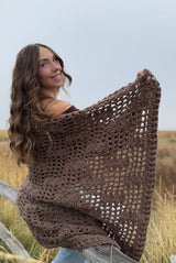 Brown afghan with mesh design wrapped around model's shoulders.  thumbnail