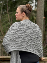 Back view of woman wearing grey cabled wrap, standing on outdoor deck thumbnail
