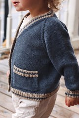 Side view of toddler cardigan showing raglan increases and pocket opening.  thumbnail