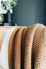 Knit throw draped over cream chair.  thumbnail