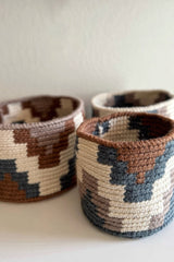 Crochet basket trio in geometric designs in cream, brown, blue, and soft tan.  thumbnail