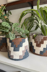 Geometric crochet baskets with potted plants inside.  thumbnail