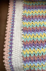 Close up of border on striped crochet blanket.  thumbnail