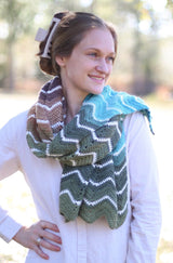Woman wears crochet chevron wrap in shades of blue and green, over white button up shirt.  thumbnail