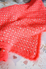 Neon coral pink afghan laid on kids bed.  thumbnail