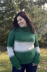 Woman with dark hair wears a crochet sweater in emerald green and cream.  thumbnail