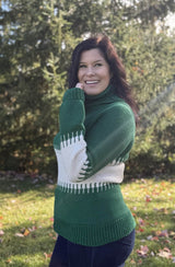 Side view of crochet sweater in emerald green top and bottom, with a stripe of cream in the middle of body and sleeves.  thumbnail