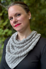 Woman with bright pink lipstick and black top wears a silver grey cabled knit cowl.  thumbnail