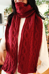 Close of of crochet scarf wrapped around model's neck with two ends hanging down.  thumbnail