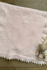 Baby blanket folded with heart motif on top.  thumbnail